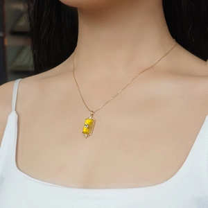 Close-up of vintage s925 silver 14k gold necklace with yellow stone pendant