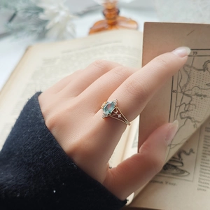 Detailed macro of a hexagonal moss agate ring with gold plated vintage band