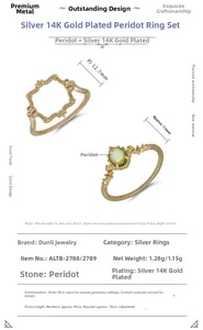 Detail of 925 silver 14K gold plated rings set with peridot and retro frame design