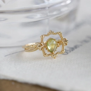 Vintage gold plated silver ring with pear cut peridot in an ornate frame setting