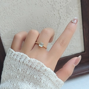 Detailed view of a mint green square gemstone ring on gold S925 sterling silver band