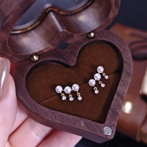 Elegant gold S925 silver pearl tassel earrings displayed in heart shaped wooden box