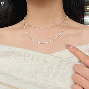 Detail view of S925 sterling silver layered necklace showing sparkling zircon chain on neck