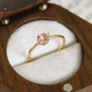 Close-up of S925 silver ring with pink gemstone and gold plating in jewelry box