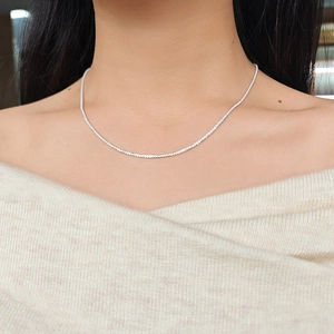 Close-up of sparkling S925 sterling silver star necklace on a female neck model