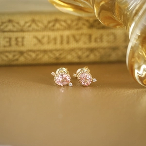Pink sapphire earrings in gold setting with arrow design and accent diamonds