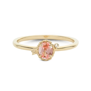 Elegant gold ring featuring an oval pink gemstone with leaf detail on a white background
