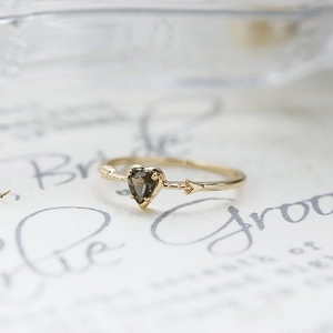 Macro shot of a heart-cut smoky quartz ring with a vintage textured gold band