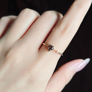 Natural smoky quartz heart ring in rose gold with unique arrow design on finger