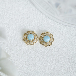 Détail de boucles d'oreilles fleurs ajourées avec Larimar et oxydes de zirconium