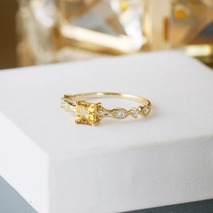 Vintage S925 silver ring with square citrine and 14K gold finish on a white pedestal