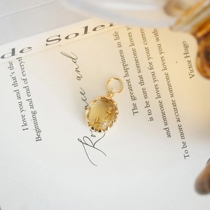 Elegant S925 silver gold-plated rose tulip pendant on an open vintage book page