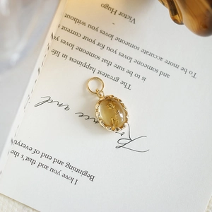 Macro view of vintage gold-plated S925 silver pendant with engraved tulip amber stone