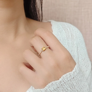 Macro view of S925 silver ring with square yellow crystal and wavy gold band