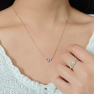 Elegant gold necklace and ring set with sky blue teardrop topaz and accent diamonds