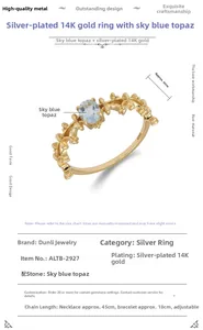 Detail of S925 silver 14K gold ring featuring sky blue topaz and floral lace design