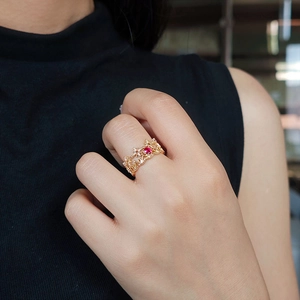 Close-up of a S925 silver 14k gold crown ring with a red gemstone and white zircons