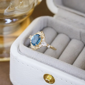 Vintage S925 silver ring with blue topaz gemstone and intricate gold floral filigree