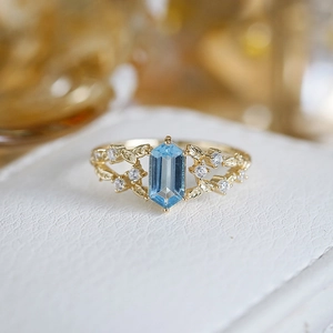 Elegant 14K gold S925 silver ring with blue topaz and leaf-shaped diamond details