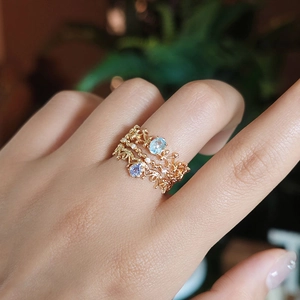 Macro shot of three-piece gold-plated S925 silver rings with blue and purple stones