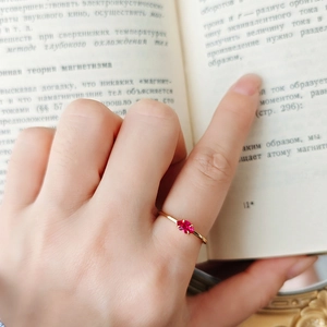 Minimalist S925 silver ring with oval red corundum stone in gold finish worn on finger