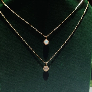 Close-up of vintage gold S925 silver necklaces with natural opal and zircon pendants