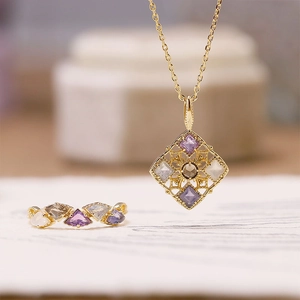 Macro shot of 925 silver gold-plated ring and necklace set with multi-colored gemstones