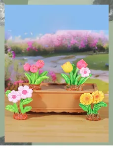 Close-up of four miniature artificial potted plants with resin tulips and sunflowers