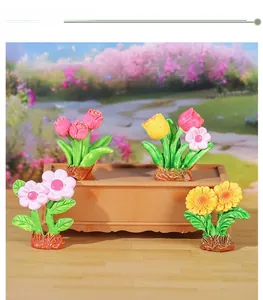 Close-up of four miniature resin potted plants featuring tulips and sunflowers for decor