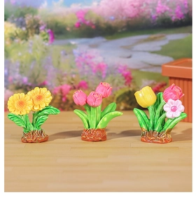 Detailed macro shot of miniature resin flower pots with realistic tulips and sunflowers