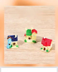 Detailed view of three miniature resin houses with brick textures for micro landscapes