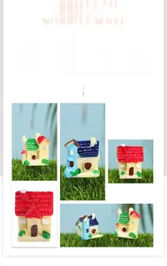 Close-up of miniature resin fairy garden cottages with colorful roofs on grass