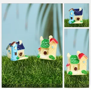 Detailed view of miniature resin houses with brick textures for terrarium garden decor