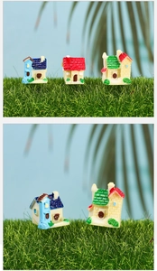 Close-up of miniature resin houses for succulent landscaping and fairy garden decor