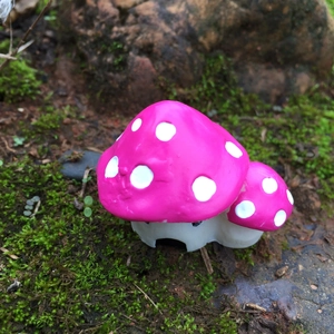 Miniature resin garden decoration featuring double red mushroom house with white polka dots