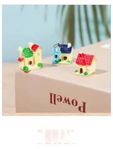Detailed macro view of three miniature cottage models on a book for micro landscapes