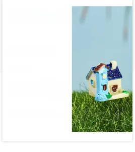 Macro detail of miniature European cottage with blue roof for succulent landscaping