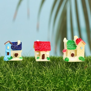 Three miniature resin fairy garden cottages on green grass for micro landscape decor