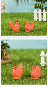 Detail of miniature resin rooster and hen figurines in a realistic micro farm landscape