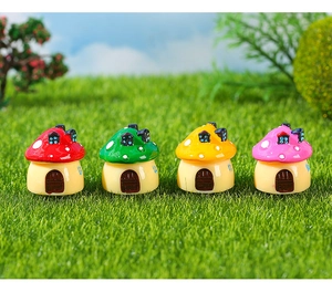 Detailed view of four colorful miniature resin mushroom houses for moss micro-landscapes
