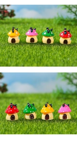 Macro detail of four colorful miniature resin mushroom houses for moss micro landscapes
