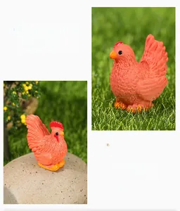 Macro shot of miniature rooster figurines with orange realistic feather texture for garden decor