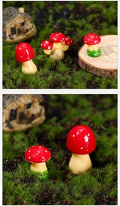 Detail von Miniatur-Fliegenpilzen aus Harz für die Dekoration von Sukkulenten-Beeten