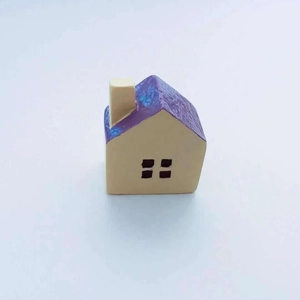 Detailed view of micro landscape castle house figurine with purple textured roof