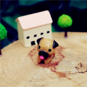 Close-up of cute resin pug figurine on wood stump for DIY bonsai micro landscape