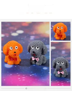 Detailed view of resin teddy dog figurines in orange and grey with cute bow tie collars