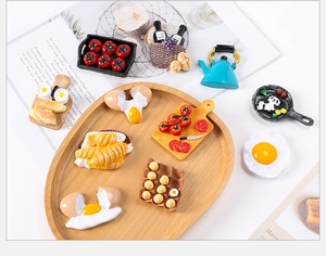 Detailed macro view of realistic resin food miniatures including fried egg and bread models