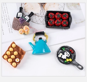 Detailed macro view of resin miniature kitchen food models including wine and panda pans