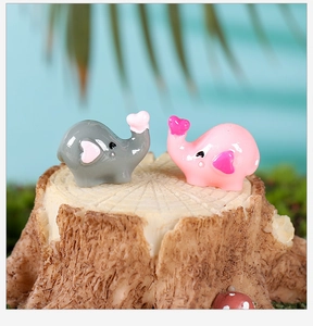 Macro view of mini resin elephant couple figurines with heart ears for bonsai