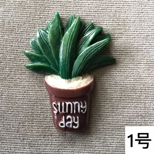 Miniature resin cactus succulent pot with Sunny Day text on a striped background